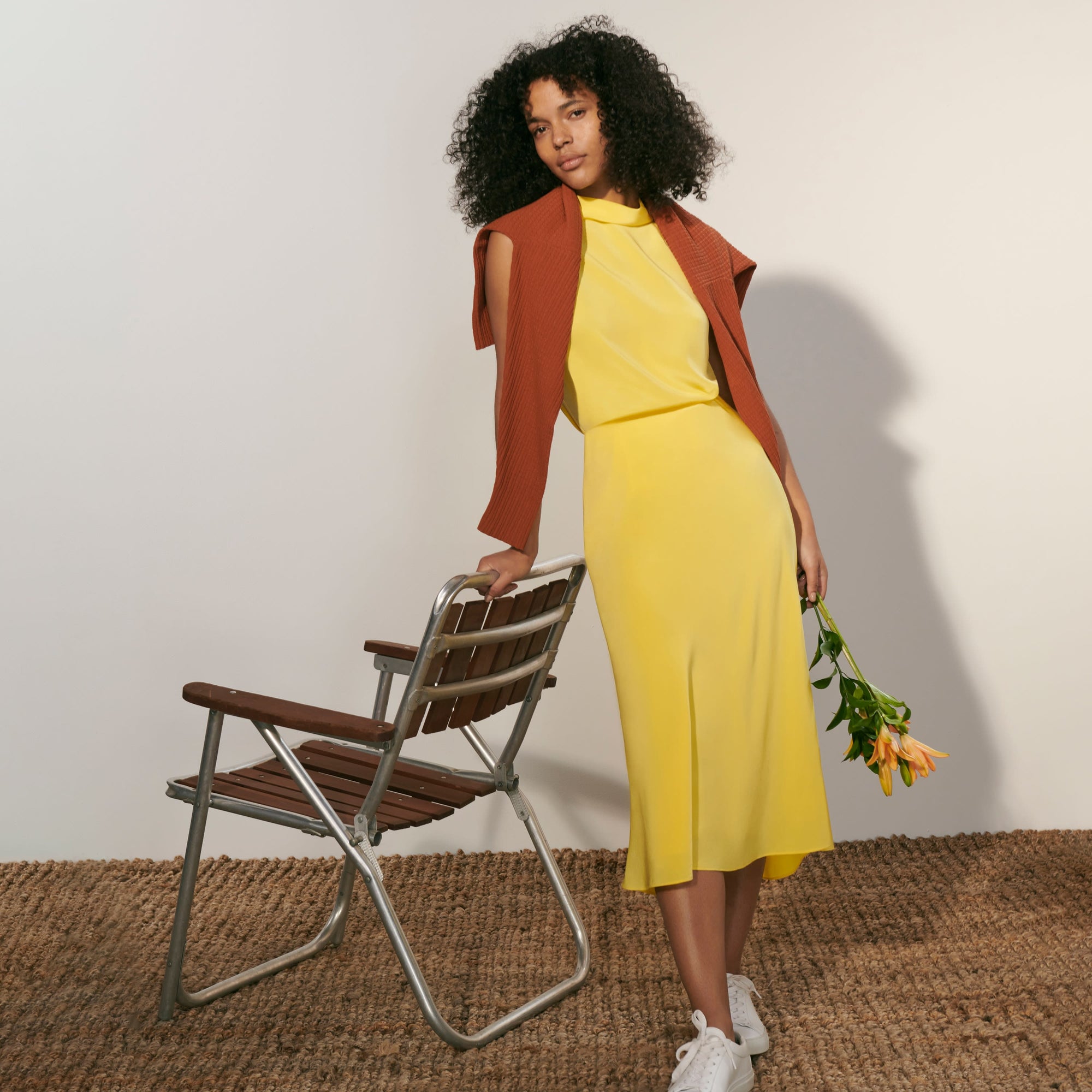 Front image of a woman standing wearing the Daisy Top—Washable Silk in Sunshine
