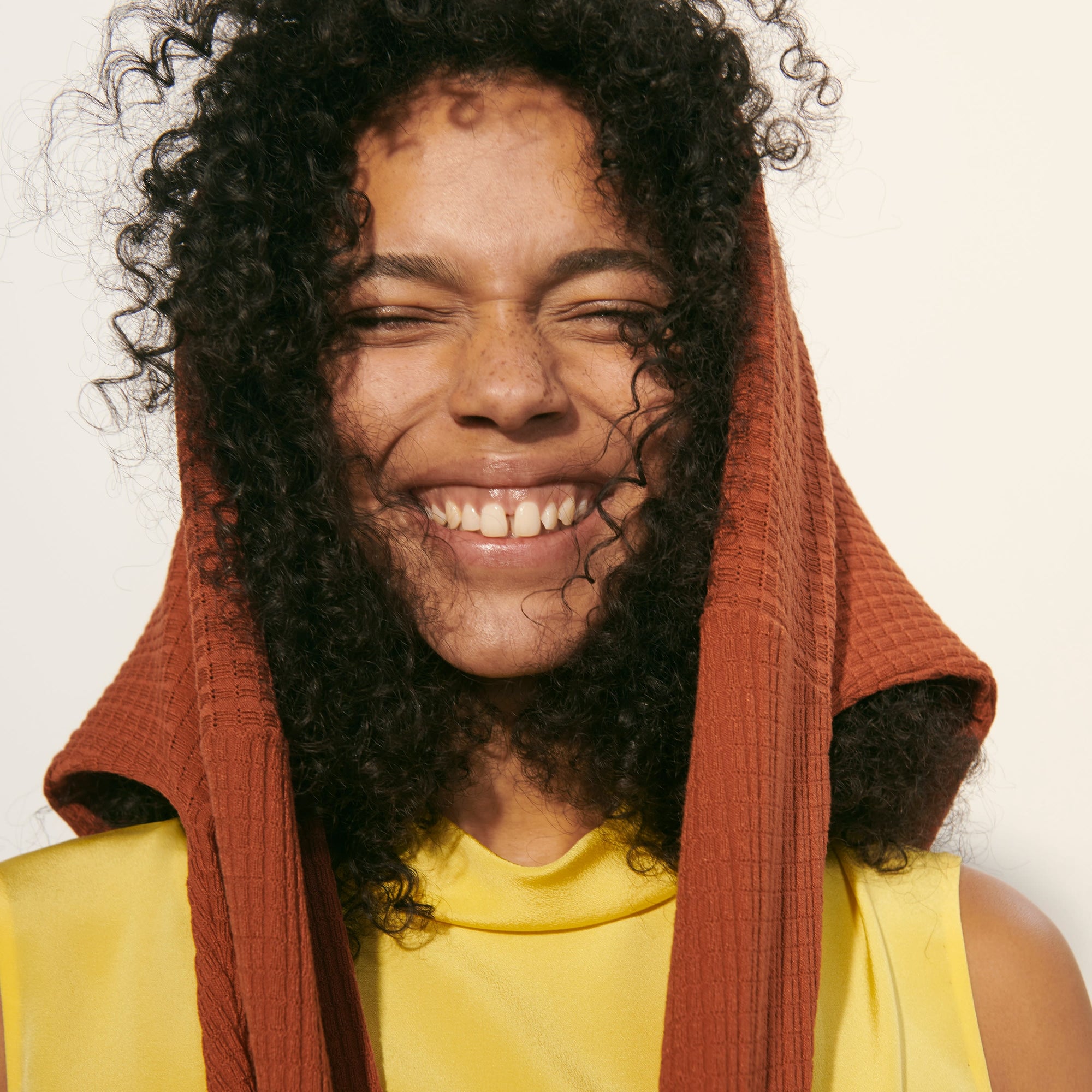 Detail image of a woman standing wearing the Daisy Top—Washable Silk in Sunshine